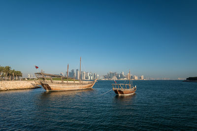 Sailboats in sea against blue sky, doha, qatar 