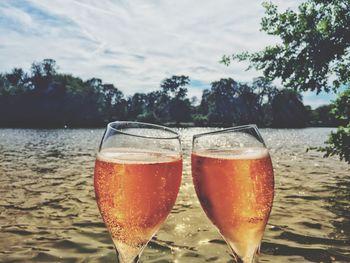 Close-up of beer in glass against sky