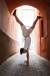 Young man exercising in archway