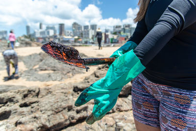 Volunteers clean up oil at rio vermelho beach in the city of salvador. 