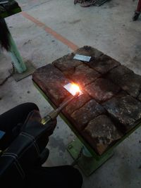 High angle view of man holding burning candles