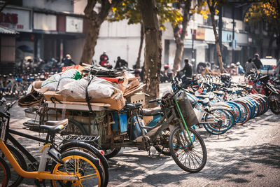 Bicycles parked on street against buildings in city