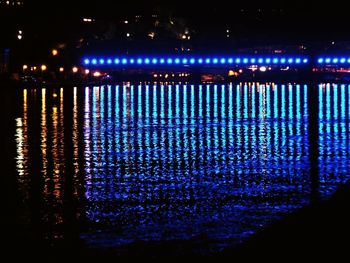 Illuminated sea against sky at night