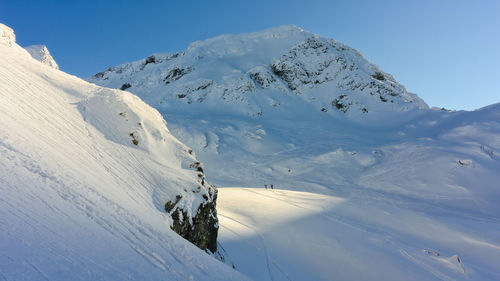 Scenic view of snow covered mountains against sky