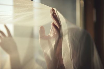 Close-up of woman in netting at home