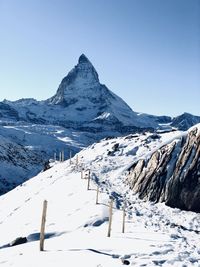 Scenic view of snow covered mountains against sky