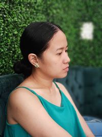 Close-up portrait of a young woman looking away