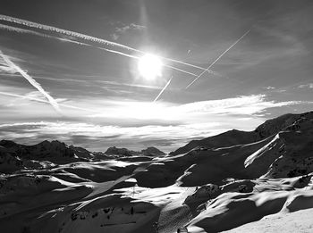 Aerial view of snowcapped mountains against sky