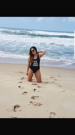 Portrait of young woman standing on beach