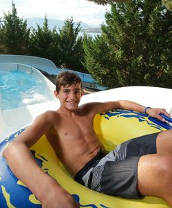 Portrait of smiling young man in swimming pool