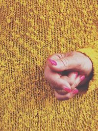 Close-up of hand on rug