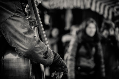 Close-up of person playing double bass