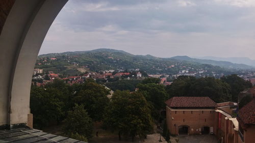 View of town against cloudy sky