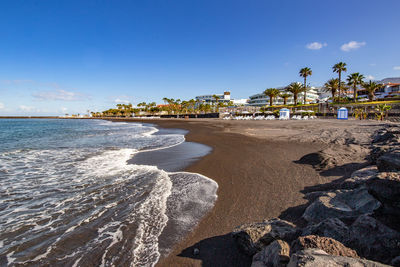 Scenic view of beach against blue sky