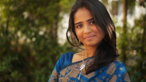 Portrait of smiling woman standing outdoors