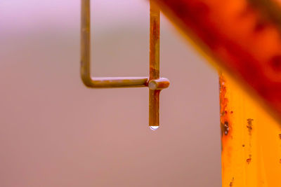 Close-up of rusty metal hanging against wall