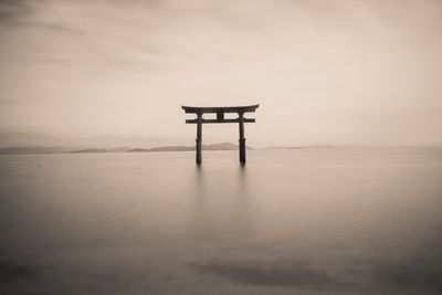 Lifeguard hut in sea against sky