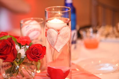 Close-up of red roses in vase on table