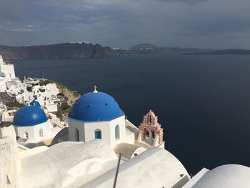 Panoramic view of sea and buildings against sky