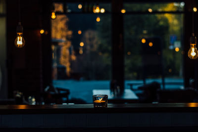 Close-up of illuminated candles on table