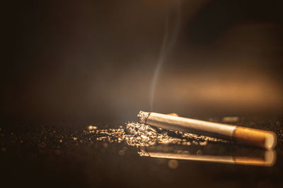Close-up of cigarette against black background