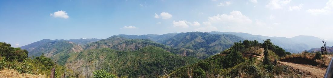 Panoramic view of trees and mountains against sky