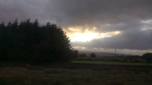 Scenic view of field against sky during sunset