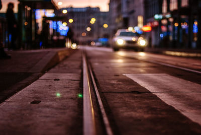 Surface level of tramway on street in city at dusk