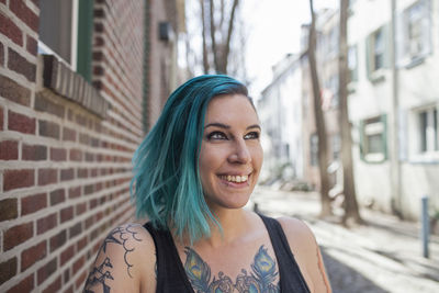 Portrait of smiling young woman in city