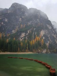 Scenic view of lake by mountains against sky