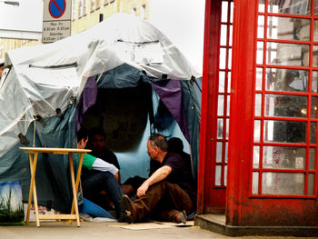 Men sitting in tent