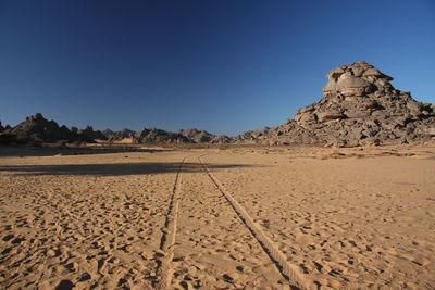 Scenic view of desert against clear blue sky acacus mountains, libya