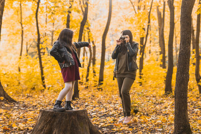 Rear view of woman standing in forest