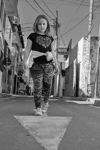Portrait of woman standing on street in city