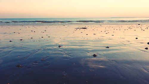 Scenic view of beach against sky during sunset