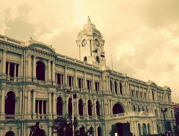 Low angle view of historic building against cloudy sky