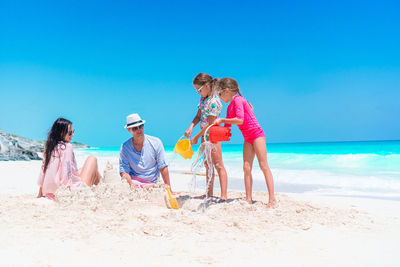 People on beach against sky