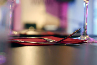 Surface level of silverwares with napkin on table