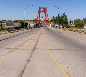 Surface level of road against sky in city