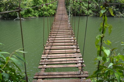 Antique bridge in lake on adjuntas puerto rico with green plants 