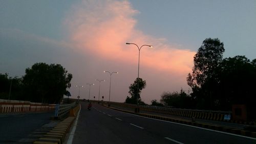 Street against sky at sunset
