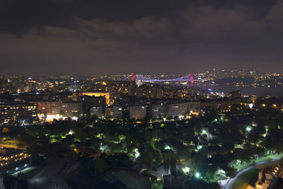 High angle view of city lit up at night