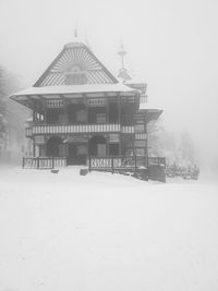 Built structure in winter against sky