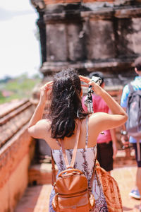 Rear view of woman walking in temple