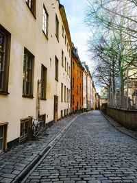 Empty alley amidst buildings in city