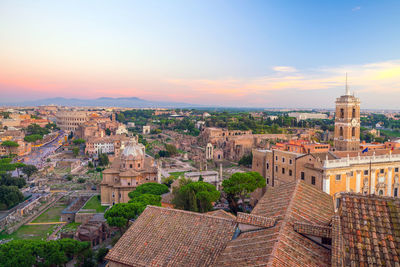 High angle view of buildings in city against sky during sunset