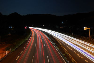 High angle view of light trails on highway at night