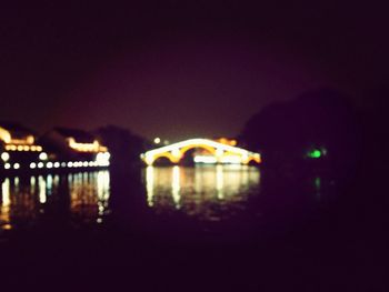 Illuminated bridge at night