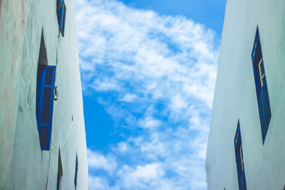 Low angle view of snow against blue sky