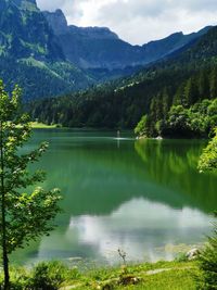 Scenic view of lake and mountains against sky